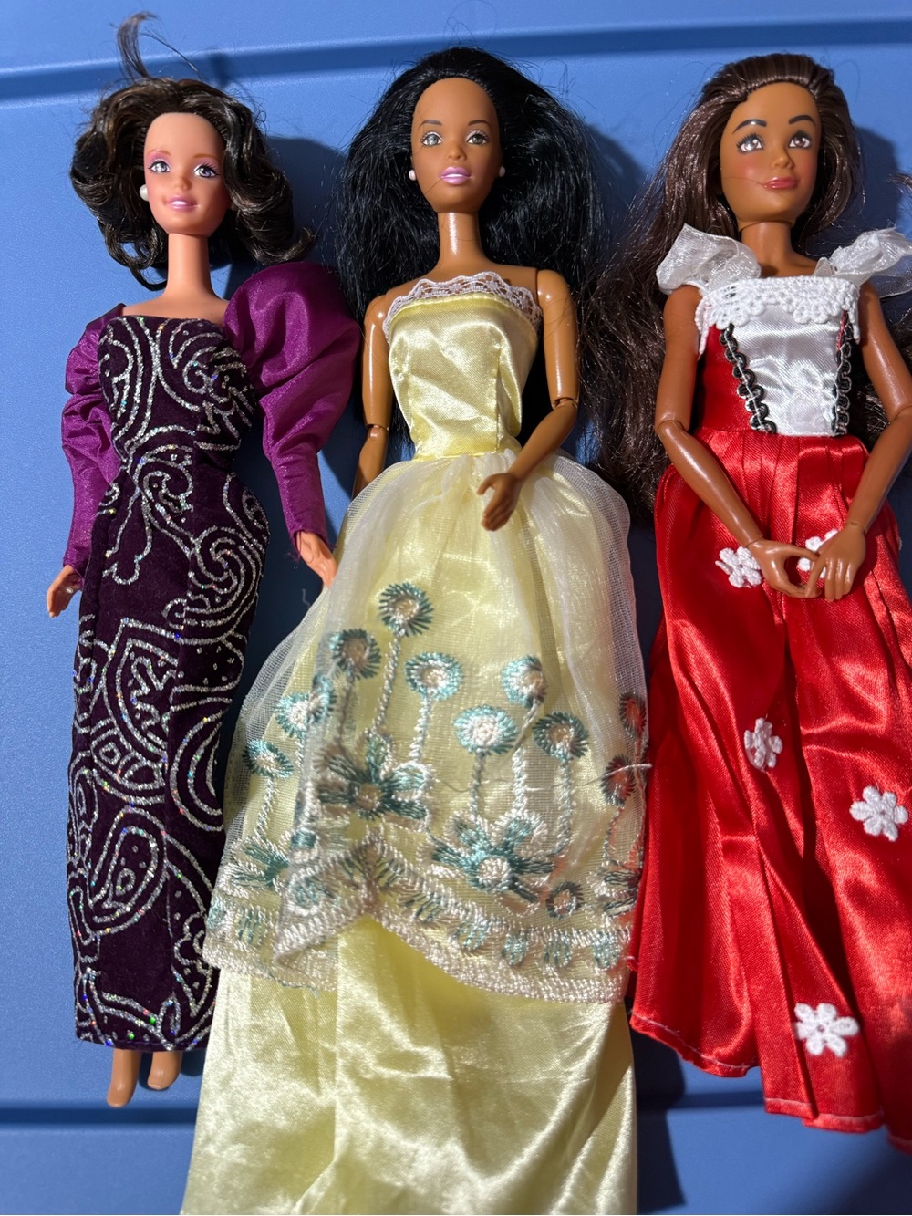 Three Fashion Barbie Dolls in Purple, Yellow, and Red Gowns